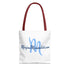 White tote bag with blue text and red handle on a white background