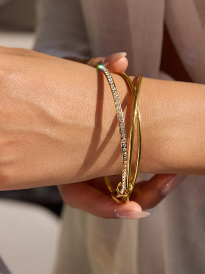 18K gold plated crossover bangle with inlaid zircon stones on a woman&